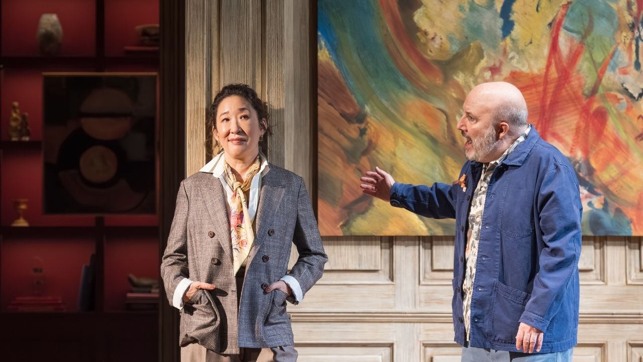 Sandra Oh on stage with a man